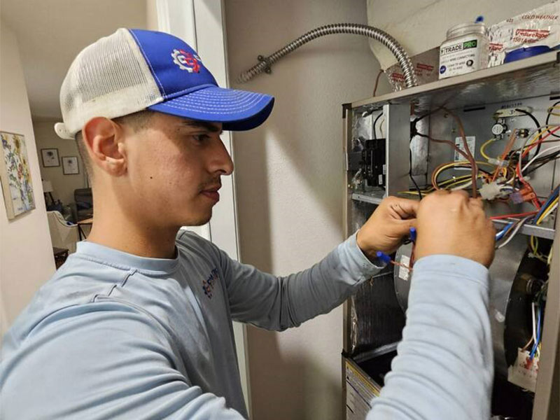 Team member repairing an AC system