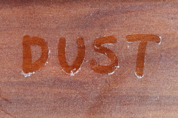Dust written in dust on a table